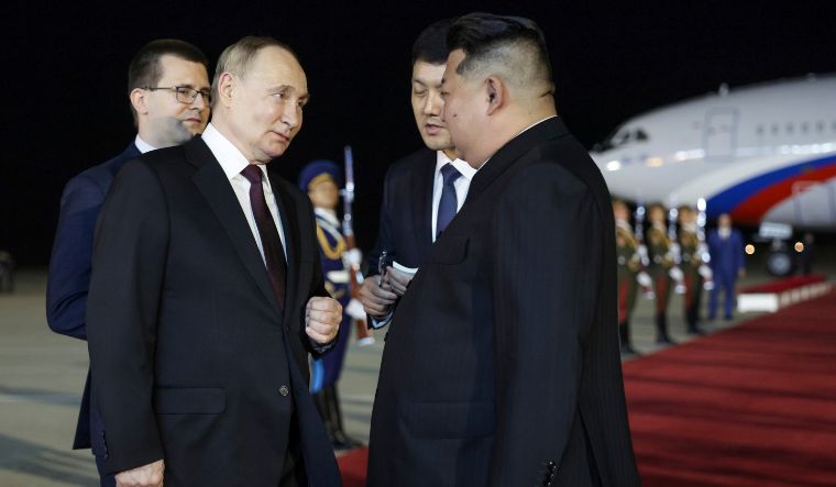 Vladimir Putin talks with Kim Jong Un